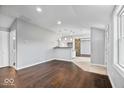 Spacious living room featuring hardwood floors, recessed lighting, and a sliding barn door at 1408 W Banta Rd, Indianapolis, IN 46217