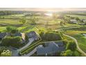 Desirable lot highlighted in yellow, backing onto a golf course with mature trees, providing privacy and scenic views at 16473 Valhalla Dr, Noblesville, IN 46060