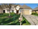 Lovely home with a well-kept lawn, mailbox, and a beige garage door under a bright blue sky at 1655 Rosebud Ln, Greenwood, IN 46143