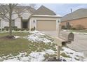 Attractive brick single-Gathering home with a manicured lawn, shrubs, and a two-car attached garage at 1655 Rosebud Ln, Greenwood, IN 46143