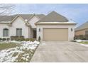 Charming single-Gathering home with a brick facade, attached two-car garage and manicured landscaping at 1655 Rosebud Ln, Greenwood, IN 46143