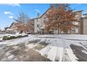 Attractive multi-story condo featuring well-maintained landscaping, with a driveway lightly dusted with snow at 240 Legends Creek Pl # Apt 205, Indianapolis, IN 46229