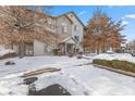 Inviting multi-story condo showcasing pristine landscaping, driveway lightly dusted with snow and mature trees at 240 Legends Creek Pl # Apt 205, Indianapolis, IN 46229