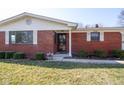 Close-up of a charming brick home with well-kept landscaping and a welcoming front entrance at 2566 S Ritter Ave, Indianapolis, IN 46203