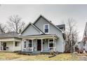 Inviting two-story home showcases neutral siding, a covered porch, and a well-maintained yard at 2962 Station St, Indianapolis, IN 46218
