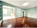 Spacious living room showcases hardwood floors and an open archway to another room at 3452 N Bancroft St, Indianapolis, IN 46218