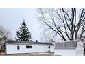 Rear exterior of a single-story home with a storage shed at 3527 N Wittfield St, Indianapolis, IN 46235