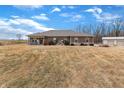Charming brick home with covered porch, serene water feature, and detached garage on a large lot at 3764 S 475 W, Trafalgar, IN 46181