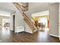 Spacious foyer with hardwood floors and staircase leading to the upper level, offering a view into the dining area at 5147 Nicodemus Dr, Plainfield, IN 46168