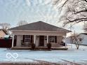 Inviting front porch with rocking chairs, complementing the home's classic architectural design at 609 Powell St, Lebanon, IN 46052