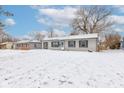 Single-story home with neutral siding and classic shutters, complemented by a snow-covered front yard and winter sky at 61 North Dr, Mooresville, IN 46158
