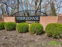 Steeplechase community sign featuring a brick base and landscaped shrubbery at 6564 Aintree Pl, Indianapolis, IN 46250