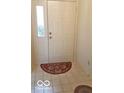 A welcoming front door with decorative glass and a classic red welcome mat at 6564 Aintree Pl, Indianapolis, IN 46250