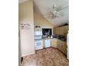 Eat-in kitchen featuring tile floors, cream colored cabinets and vaulted ceiling at 6564 Aintree Pl, Indianapolis, IN 46250