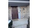 Inviting front door with brick surround, sidelight, and neutral colors provides a warm welcome at 9266 Backwater Dr, Indianapolis, IN 46250