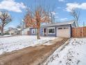 A lovely one-story home with blue siding, an attached garage, and a driveway, pictured in winter at 930 Edgewood Dr, Mooresville, IN 46158