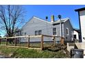 Backyard of a gray home with a neatly bordered fence on a sunny day at 1046 Nelson Ave, Indianapolis, IN 46203