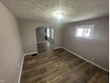 Open living room featuring updated flooring, neutral paint, and a charming archway to the next room at 1105 Winfield Ave, Indianapolis, IN 46222