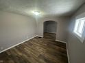 Inviting living room with modern wood-look flooring and an archway leading to another room at 1105 Winfield Ave, Indianapolis, IN 46222