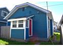 The side of the house is blue with a small awning over a red door at 1328 E Minnesota St, Indianapolis, IN 46203