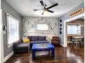 Cozy living room featuring hardwood floors and a wall with musical accents at 1328 E Minnesota St, Indianapolis, IN 46203