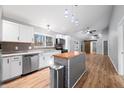 Well-lit kitchen featuring a center island, modern stainless appliances, and tiled backsplash at 150 W Jo Jo Ln, Nineveh, IN 46164