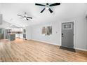 Open-concept living room with wood-look floors, vaulted ceilings, and abundant natural light at 150 W Jo Jo Ln, Nineveh, IN 46164