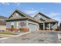Well-maintained single-Gathering home with attached garage, blue siding, and brick accents at 15179 Kampen Cir, Carmel, IN 46033