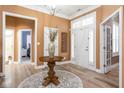 Welcoming foyer with hardwood floors, wainscoting, and ample natural light at 15179 Kampen Cir, Carmel, IN 46033