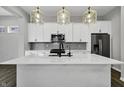 Modern kitchen with stainless steel appliances, white cabinets, and a large island at 1538 Cloverdon Dr, Westfield, IN 46074