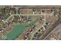 Aerial view of neighborhood with mature trees and proximity to green space at 16246 Remington Dr, Fishers, IN 46037