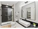 Modern bathroom with sleek black finishes, tiled shower, floating vanity and large mirror at 16246 Remington Dr, Fishers, IN 46037