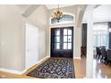 Grand entryway showcasing double doors, a decorative rug, and archways leading to other living spaces at 2110 Cheviot Ct, Greenwood, IN 46143
