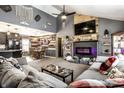 Open living room with vaulted ceilings, a fireplace, a large sectional, and a coffee table at 2758 S Lyons Ave, Indianapolis, IN 46241