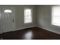 Bright living room featuring hardwood floors, and natural light from two windows at 3160 Graceland Ave, Indianapolis, IN 46208