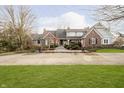 Beautiful brick home with large front yard, manicured landscape and paved driveway at 3803 Nesbitt Rd, Indianapolis, IN 46220