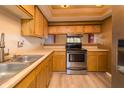 Bright kitchen featuring wood cabinets, light countertops, and a stainless steel range at 4247 Larkspur Trce, Indianapolis, IN 46237