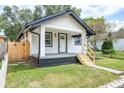 This home features a well-kept lawn, classic siding, and inviting front porch at 509 St Paul St, Indianapolis, IN 46203