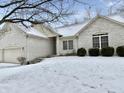 Charming single Gathering home with a brick exterior, attached garage and snow covered front yard at 5791 Station Hill Dr, Avon, IN 46123
