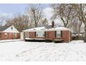 Charming brick ranch home featuring an attached garage and a well-maintained front yard at 5838 Brouse Ave, Indianapolis, IN 46220