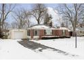Charming brick ranch home featuring an attached garage and a well-maintained front yard at 5838 Brouse Ave, Indianapolis, IN 46220
