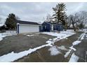Charming blue home with a two-car garage and front porch at 6018 Ivanhoe St, Indianapolis, IN 46219