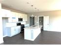 Bright kitchen features an island with a sink and white cabinetry at 640 Firefly Ct, Greenfield, IN 46140