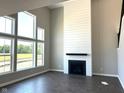 Open concept living room with fireplace and large windows overlooking the backyard at 640 Firefly Ct, Greenfield, IN 46140