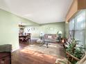 Inviting living room featuring hardwood floors, green walls and a view into the dining room at 6740 Live Oak Ct, Indianapolis, IN 46214