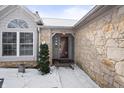 Inviting entryway featuring a stone facade and a well-lit front door at 6751 Wild Cherry Dr, Fishers, IN 46038
