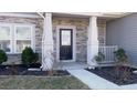 Inviting entryway with stone pillars and a walkway at 7139 Prelude Rd, Brownsburg, IN 46112