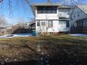 Back of home features a small yard with sparse grass, a blue trash can and a door leading inside at 754 N Bancroft St, Indianapolis, IN 46201