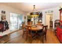 Inviting dining area with hardwood floors, pendant lighting, and access to an outdoor porch at 7968 E 200 S, Whitestown, IN 46075