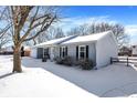 Snow covered exterior showcasing the side of the house with well-maintained landscaping and bare trees at 935 Elmwood Cir, Noblesville, IN 46062